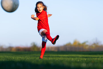 Fototapeta na wymiar Little girl in a soccer training