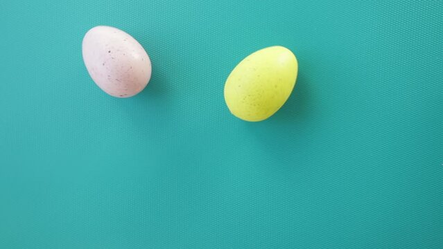 easter eggs roll, spin on a blue background, colorful holiday decorations