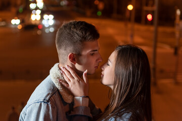 Couple of students intend to kiss against evening city backdrop. Date. Romance.