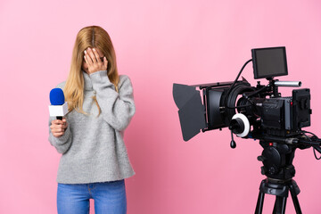 Reporter woman holding a microphone and reporting news over isolated pink background with tired and...