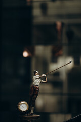 Vintage watch in the shape of a golfer on a dark background