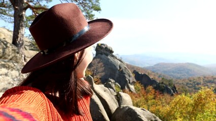 smiling woman in hat taking selfie enjoying sunny autumn weather