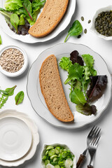 Healthy eating, dieting.  Whole wheat bread and greenery, ready to eat