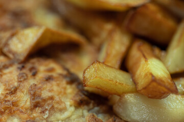 Fried potatoes. Hot fried sliced potatoes. French fries.