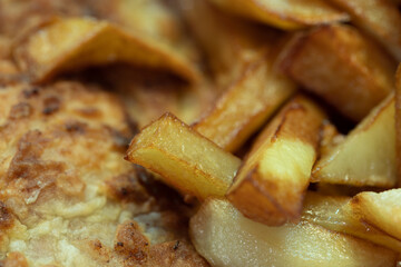 Fried potatoes. Hot fried sliced potatoes. French fries.