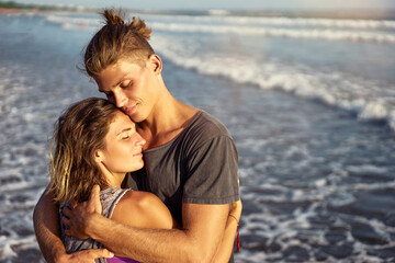 Love and romance. Honeymoon on the sea shore. Beautiful loving couple embracing on the beach.