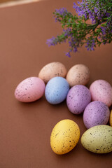 Naklejka na ściany i meble Colored easter eggs on a brown background