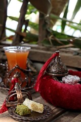 Indian desserts sweet and fruit tea on wood background
