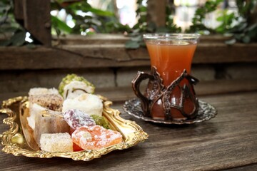 Indian desserts sweet and fruit tea on wood background