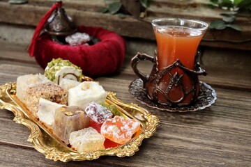 Indian desserts sweet and fruit tea on wood background