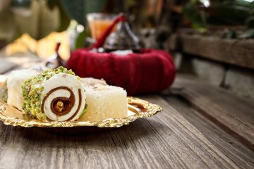 Indian desserts sweet and fruit tea on wood background