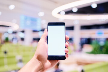 Male hand holding smartphone with copy space on the screen.