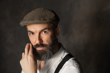 Portrait of mature bearded man in vintage style. Hipster concept. High quality photo