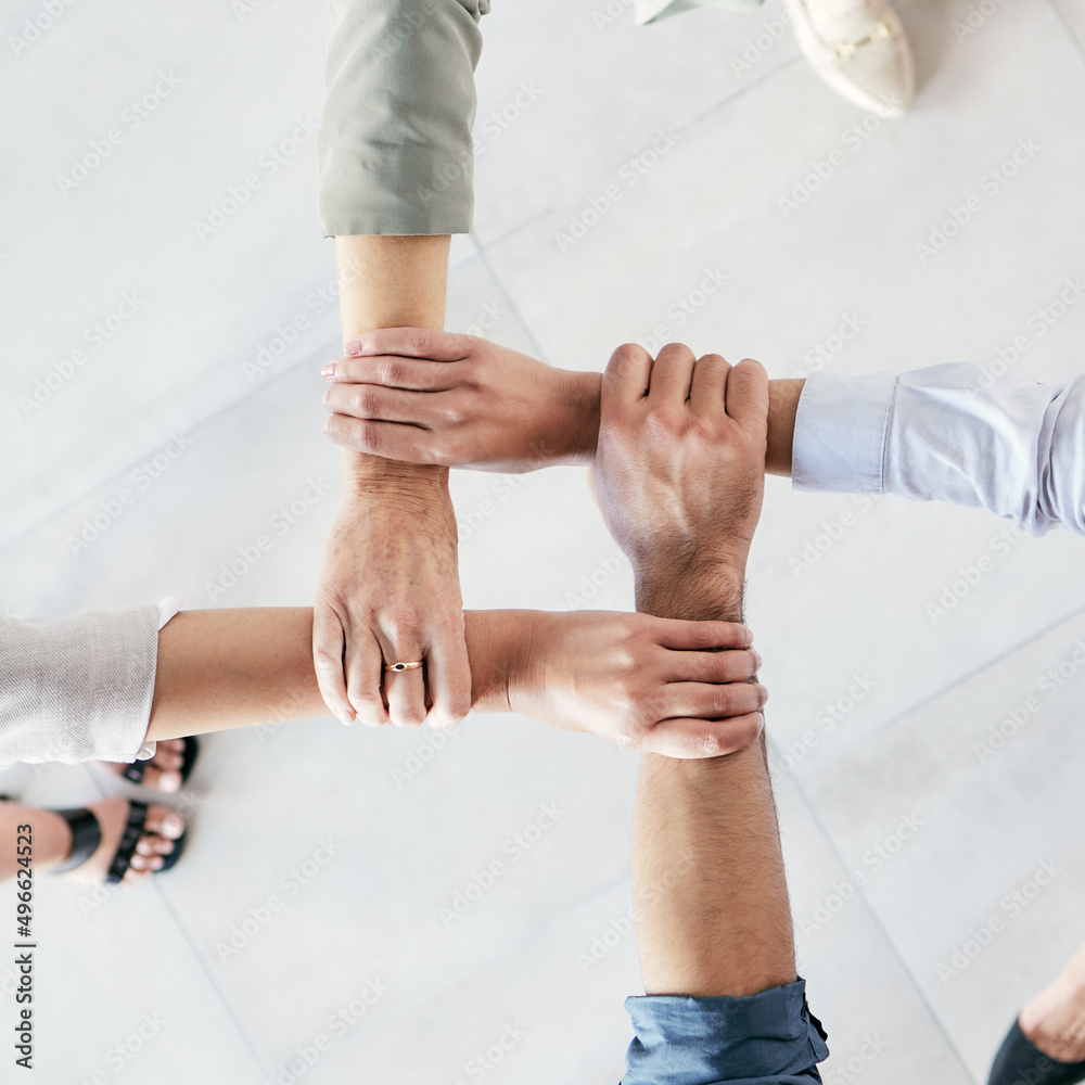 Poster developing a good work ethic is key. cropped shot of a group of businesspeople linking their arms in