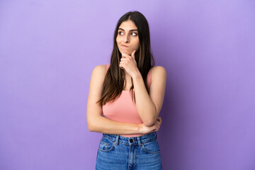 Young caucasian woman isolated on purple background having doubts and thinking