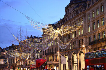 Angel Christmas decorations in evening London with double-decker buses in sight, Regent street