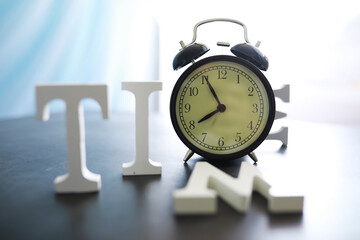 Big alarm clock. The clock is on the table. The inscription 