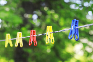 Clothespins on a clothesline in summer. Dry clothes outside. Clothes on a rope.