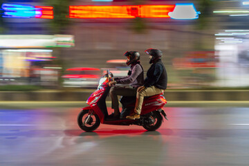 Naklejka premium Motorcycle rider and passenger going to their destination. It's a panning picture. 