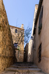 narrow pedestrian cobblestone street leading through the historic old buildings in the Old Town...
