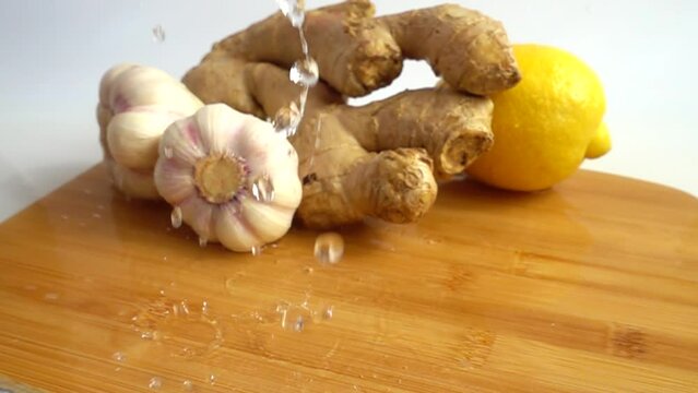 Juicy lemon, garlic and ginger on a carving wooden