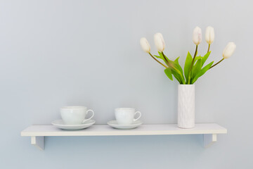 Two cups with a bouquet of tulips