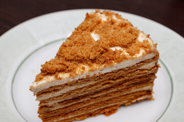A piece of delicious cream cake on a grater.