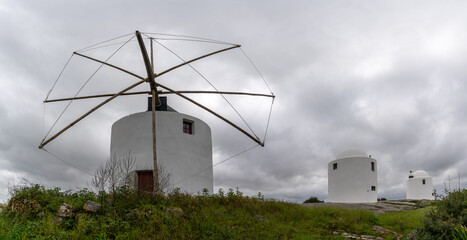 the windmills of Sao Bento of Evora under an expressive overcast sky