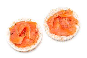 Naklejka na ściany i meble Tasty Rice Cake Sandwiches with Fresh Salmon Slices Isolated on White - Top View. Easy Breakfast and Diet Food. Crispbread with Red Fish. Healthy Dietary Snacks - Isolation