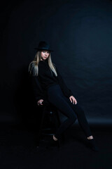 girl in black in the studio in a dark key