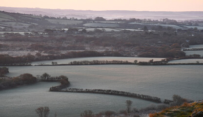 Frosted fields below Helman Tor Cornwall at sunrise