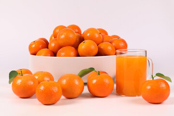 oranges, healthy fruit, mandarin oranges, orange juice in glass, vitamin C, against a white background with refreshing drops of water