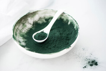 spirulina algae powder in a white bowl