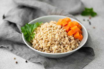 boiled pearl barley with butter in a gray plate