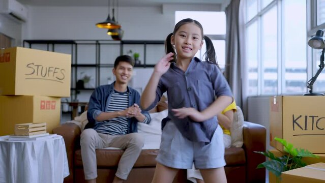 Happiness Asian Daughter Dancing Show Her Parent With Cheerful Funny Movement While Break After Packing Stuff And Things In Cardboard Box Home Moving Ideas Concept,asain Family Home Packing At Home