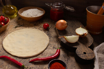 Pizza homemade cooking with ingredients on table. Dough pizza on tabletop