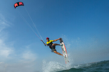 A kite surfer rides the waves