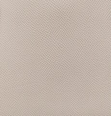 Soft beige leather texture with print as background, surface beige leather background.