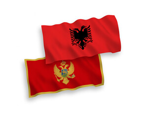 National vector fabric wave flags of Montenegro and Albania isolated on white background. 1 to 2 proportion.