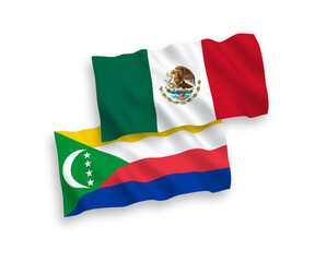 National vector fabric wave flags of Mexico and Union of the Comoros isolated on white background. 1 to 2 proportion.