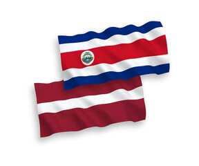 National vector fabric wave flags of Latvia and Republic of Costa Rica isolated on white background. 1 to 2 proportion.