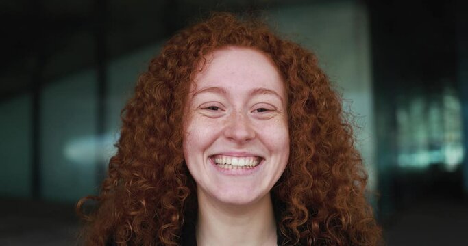 Happy readhead girl smiling on camera outdoor
