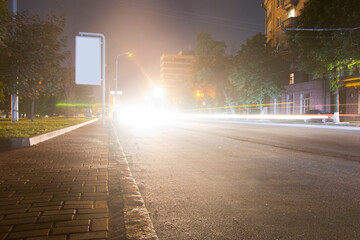 beam of car headlights on the street of the night city