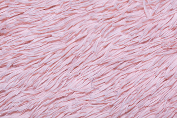 Pink fur texture top view. Abstract wallpaper, textile surface. Coral fluffy fabric coat background. Winter fashion color trends feminine flat lay, female blog backdrop for text signs desidgn. 