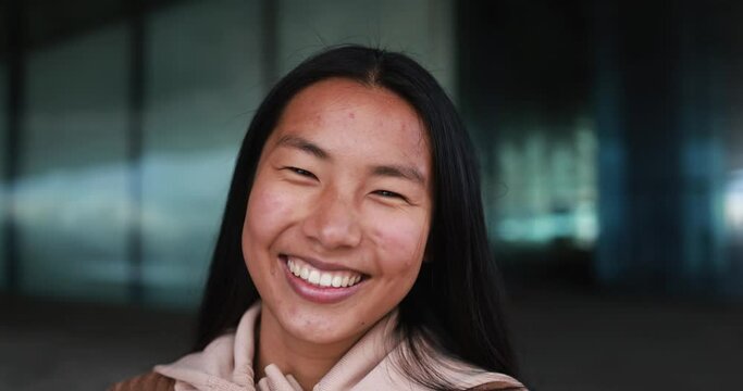 Young asian girl smiling on camera outdoor