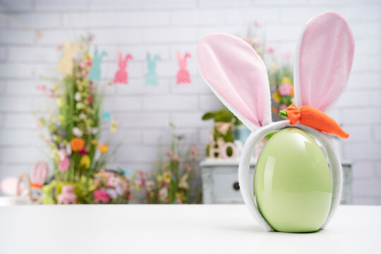 Easter time. Easter decorations on the white background. Easter bunny, easter eggs in basket. Bouquets of spring flowers. 