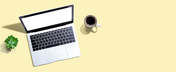 Laptop computer with a coffee cup from above
