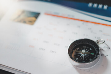 Black compass on calendar selective focus and vintage color effect