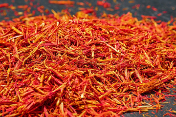 Saffron threads on dark background, close up, selective focus. Aromatic spices and seasonings