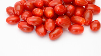 Close up pile of juicy organic tomato and fresh shiny red cherry tomatoes with shape tapering isolated on white background. health fruit concept